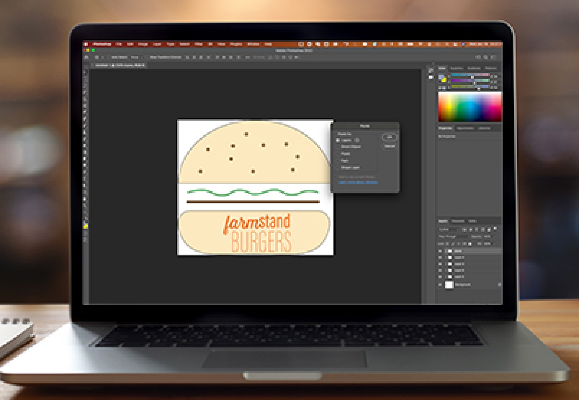 Image of laptop with Photoshop open to show layers from Illustrator