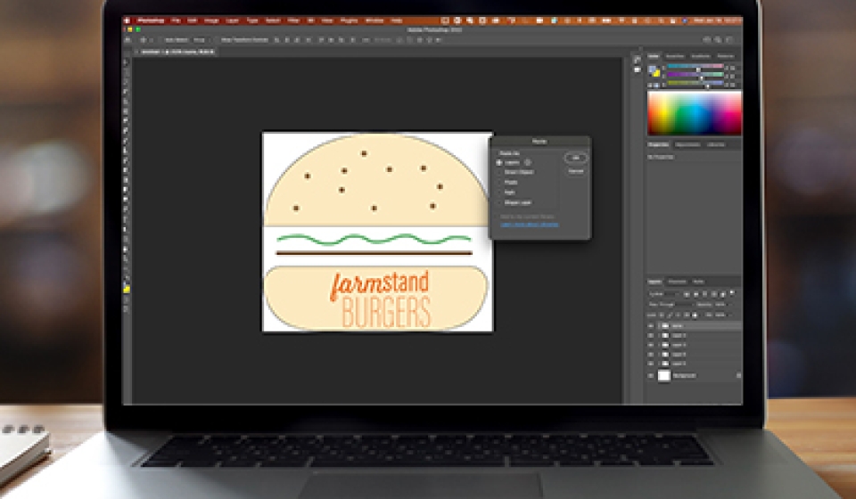 Image of laptop with Photoshop open to show layers from Illustrator