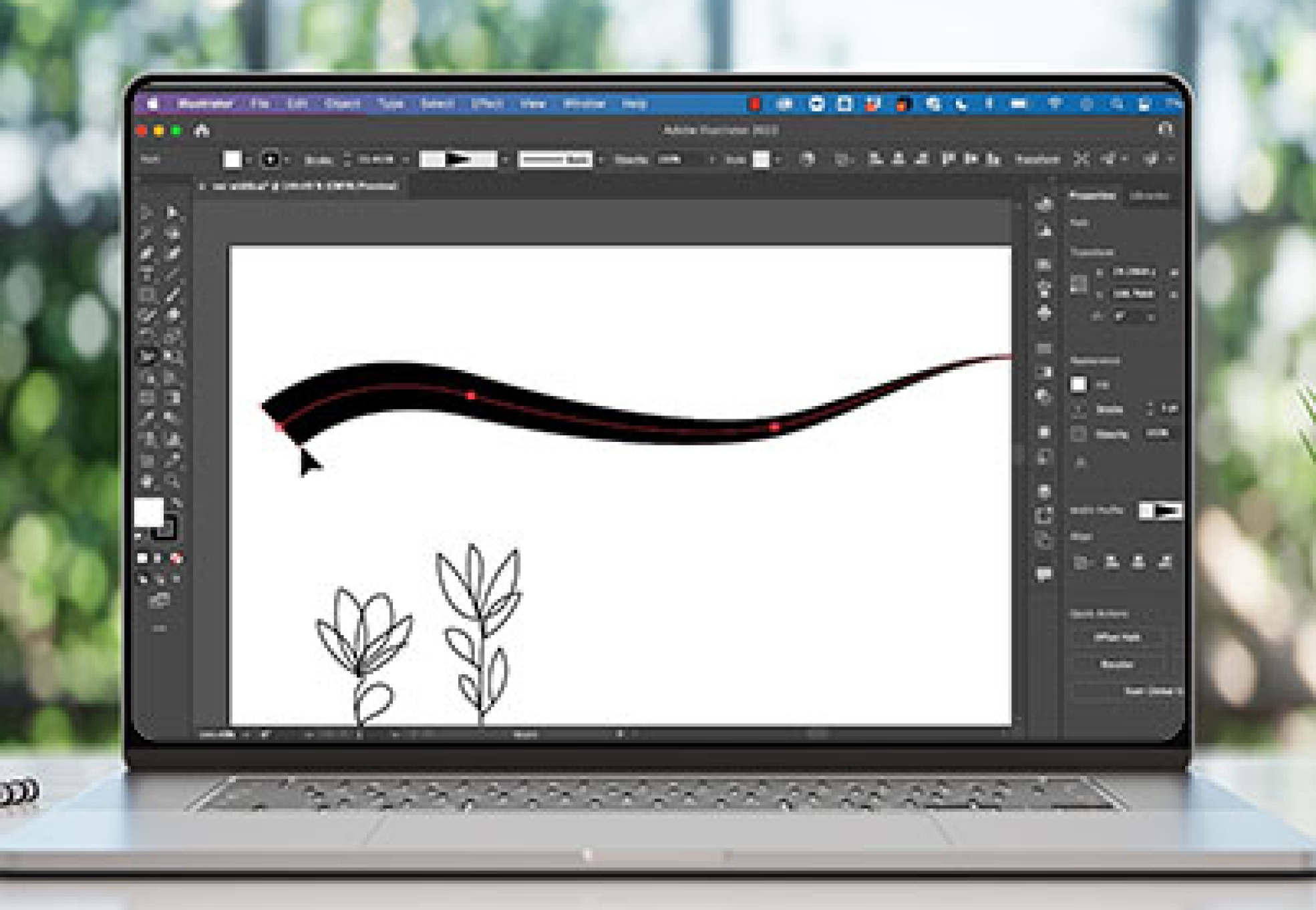 Laptop with Illustrator on the screen on a table